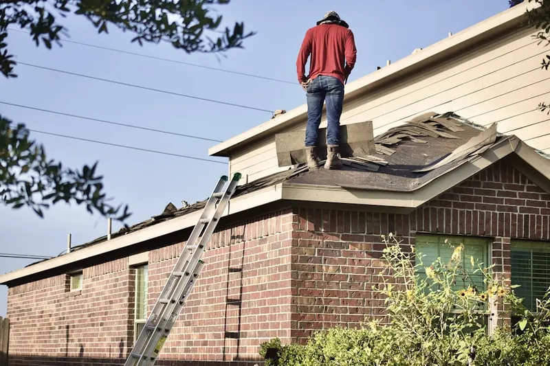 Professional roofer working on a residential roof in Peachtree Station